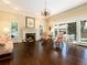 Bright living room with a fireplace, large windows, hardwood floors, and elegant chandelier at 2552 E Alameda Ave # 16, Denver, CO 80209