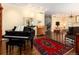 Bright living room with hardwood floors, piano, and classic furnishings create an inviting atmosphere at 2552 E Alameda Ave # 16, Denver, CO 80209