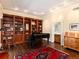 Charming living room featuring a built-in bookcase, wet bar, and hardwood floors with natural light at 2552 E Alameda Ave # 16, Denver, CO 80209