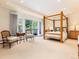 Inviting main bedroom featuring a four poster bed, natural light, and serene decor at 2552 E Alameda Ave # 16, Denver, CO 80209