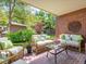 Relaxing covered brick patio with comfortable seating, perfect for outdoor entertaining and enjoying the backyard at 2552 E Alameda Ave # 16, Denver, CO 80209