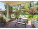 Outdoor patio area featuring wicker seating, brick flooring, and covered roof at 2552 E Alameda Ave # 16, Denver, CO 80209