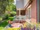 Picturesque patio with brick flooring, perfect for outdoor dining and relaxation, surrounded by vibrant flowers and lush landscaping at 2552 E Alameda Ave # 16, Denver, CO 80209