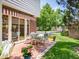 Charming outdoor patio with brick flooring, awning, and a table with comfortable seating, perfect for entertaining at 2552 E Alameda Ave # 16, Denver, CO 80209