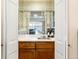 Attractive wet bar featuring white countertop, sink, and mirrored shelving at 2552 E Alameda Ave # 16, Denver, CO 80209