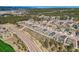Aerial view of homes in a new residential community nestled among trees with mountains in the distance at 668 Sage Forest Ln, Monument, CO 80132