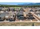 Stunning aerial view of a neighborhood with well-maintained homes, lawns, and mountain backdrop at 668 Sage Forest Ln, Monument, CO 80132