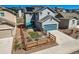 Photo of a backyard with a small patio, fenced yard and blue garage door in a new home at 668 Sage Forest Ln, Monument, CO 80132