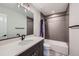 Stylish bathroom featuring a modern vanity, bathtub with shower, and contemporary fixtures at 668 Sage Forest Ln, Monument, CO 80132