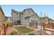Charming home with a well-maintained yard, patio, and blue garage door, providing curb appeal at 668 Sage Forest Ln, Monument, CO 80132
