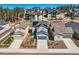 Aerial view of home with solar panels, blue garage door, and fenced yard with patio furniture at 668 Sage Forest Ln, Monument, CO 80132