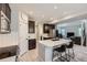 Modern kitchen features stainless appliances, granite countertops, dark cabinets, and island with breakfast bar at 668 Sage Forest Ln, Monument, CO 80132