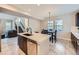 This kitchen boasts an island with seating, sleek countertops, and dark cabinetry, perfect for modern living at 668 Sage Forest Ln, Monument, CO 80132
