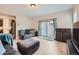 Spacious living room featuring a sliding glass door and light hardwood flooring at 668 Sage Forest Ln, Monument, CO 80132