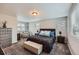 Spacious main bedroom offers comfort and style with plush carpeting, natural light, and elegant furnishings at 668 Sage Forest Ln, Monument, CO 80132