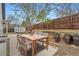 Cozy backyard features a dining table and chairs, privacy fence, and shed at 4723 S Pagosa Way, Aurora, CO 80015