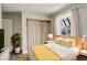 Cozy bedroom with wood bed frame and yellow accents at 4723 S Pagosa Way, Aurora, CO 80015