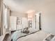 Bright bedroom featuring wood floors, built-in closets, and comfortable decor at 4723 S Pagosa Way, Aurora, CO 80015