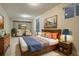 Spacious bedroom with neutral colors, a wooden bed frame, and a cozy sitting area at 4723 S Pagosa Way, Aurora, CO 80015