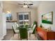 Spacious dining area with glass table and mid-century modern buffet at 4723 S Pagosa Way, Aurora, CO 80015