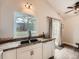 Bright kitchen featuring a double basin sink, granite countertops, and white cabinets at 4723 S Pagosa Way, Aurora, CO 80015