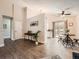 Open-concept living room with hardwood floors, a dining area, and a glimpse into the kitchen with a sliding door at 4723 S Pagosa Way, Aurora, CO 80015