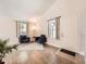 Bright living room featuring hardwood floors, vaulted ceilings, two armchairs, and natural light from a window at 4723 S Pagosa Way, Aurora, CO 80015