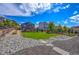 Backyard with a lush lawn, landscaping and a rock garden at 6630 S Coolidge Ct, Aurora, CO 80016