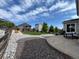 Landscaped backyard featuring a patio, a manicured lawn, and stone pathways leading to the home at 6630 S Coolidge Ct, Aurora, CO 80016