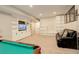 Finished basement featuring a pool table, a comfortable sofa, and custom built-in shelving for storage at 6630 S Coolidge Ct, Aurora, CO 80016