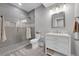 Bathroom features a glass shower, neutral tile and bright vanity lighting at 6630 S Coolidge Ct, Aurora, CO 80016
