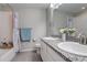 Bathroom with double sinks, granite countertop, tile flooring and a bathtub with shower, providing comfort and style at 6630 S Coolidge Ct, Aurora, CO 80016