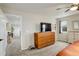 Cozy bedroom with carpet flooring, ceiling fan, and a wooden dresser with a TV on top for relaxed entertainment at 6630 S Coolidge Ct, Aurora, CO 80016