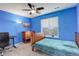 Blue bedroom with a comfortable bed, wood furniture, and a ceiling fan offering a cozy and inviting atmosphere at 6630 S Coolidge Ct, Aurora, CO 80016