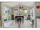 Bright dining area with large windows offering views of the outdoors, wood floors and modern decor at 6630 S Coolidge Ct, Aurora, CO 80016