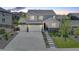Charming two-story home with a three car garage, stone accents, landscaped front yard and long driveway at 6630 S Coolidge Ct, Aurora, CO 80016