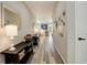 Bright hallway with wood floors, decorated walls, and a view into the living spaces at 6630 S Coolidge Ct, Aurora, CO 80016