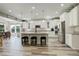 Spacious kitchen with white cabinets, stainless steel appliances, and a large island at 6630 S Coolidge Ct, Aurora, CO 80016