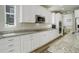 Stylish kitchen featuring white cabinets, granite countertops, and stainless steel appliances at 6630 S Coolidge Ct, Aurora, CO 80016