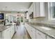Bright, well-appointed kitchen with stainless steel appliances, granite countertops, and a clear view to the breakfast nook at 6630 S Coolidge Ct, Aurora, CO 80016