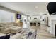 Open-concept living room with modern kitchen, stainless appliances, and a cozy fireplace at 6630 S Coolidge Ct, Aurora, CO 80016