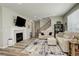 Comfortable living room with a fireplace, staircase, and plush seating at 6630 S Coolidge Ct, Aurora, CO 80016