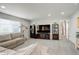 Cozy living room with ample seating, bookshelves, and natural light from the window at 6630 S Coolidge Ct, Aurora, CO 80016