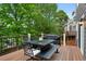 Inviting back deck with a dining table, grill, and seating for outdoor entertaining at 7027 Chestnut Hill St, Highlands Ranch, CO 80130