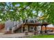 A spacious deck overlooks a beautifully paved patio and backyard, perfect for outdoor gatherings and relaxation at 7027 Chestnut Hill St, Highlands Ranch, CO 80130