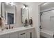 Elegant bathroom with double sinks, modern fixtures, and a separate bathtub at 7027 Chestnut Hill St, Highlands Ranch, CO 80130