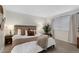 Cozy bedroom featuring neutral paint, carpet, and a large window at 7027 Chestnut Hill St, Highlands Ranch, CO 80130