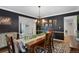 Dining room with dark walls, decorative lighting, and seating for six at 7027 Chestnut Hill St, Highlands Ranch, CO 80130