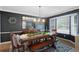 Formal dining room showcasing dark walls, decorative lighting, and seating for eight at 7027 Chestnut Hill St, Highlands Ranch, CO 80130