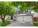 Charming two-story home boasts a three-car garage, well-manicured lawn, and lovely landscaping, perfect for curb appeal at 7027 Chestnut Hill St, Highlands Ranch, CO 80130